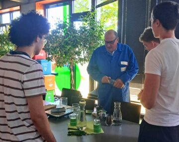 Dr. Klaus Vitalis Schulz talks to the advanced chemistry class about different ways to make coffee and how these methods connect to cleaning technology.