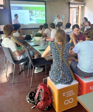 Dr Klaus Vitalis Schulz and Mark Sethe are presenting the company and its business processes to the advanced mathematics class.